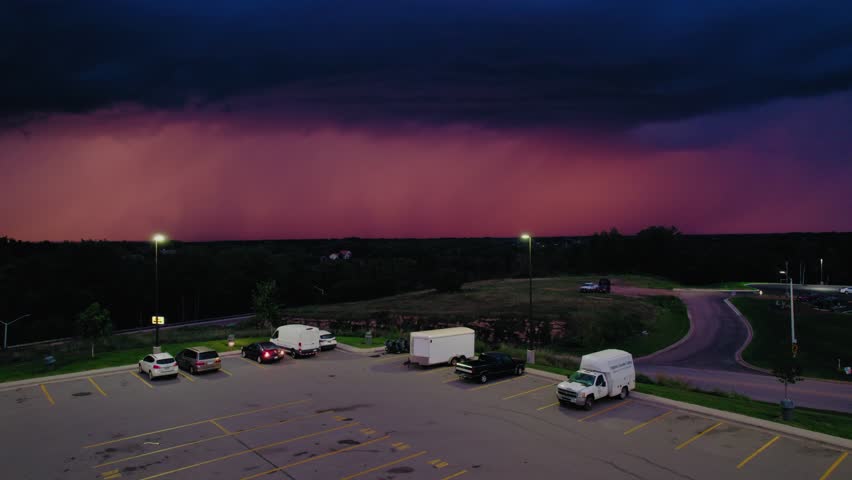 Powerful bolt of lightning illuminates a dramatic, colorful storm cloud. Perfect for projects about weather, climate, or nature.