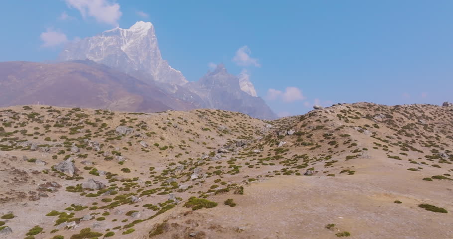 Drone gliding view of Dingboche village at 4,410m in Khumbu, Nepal. A high-altitude residence Everest Base Camp trek, surrounded by 8000m Himalayan peaks dreamy nature conservation scene of dry lands