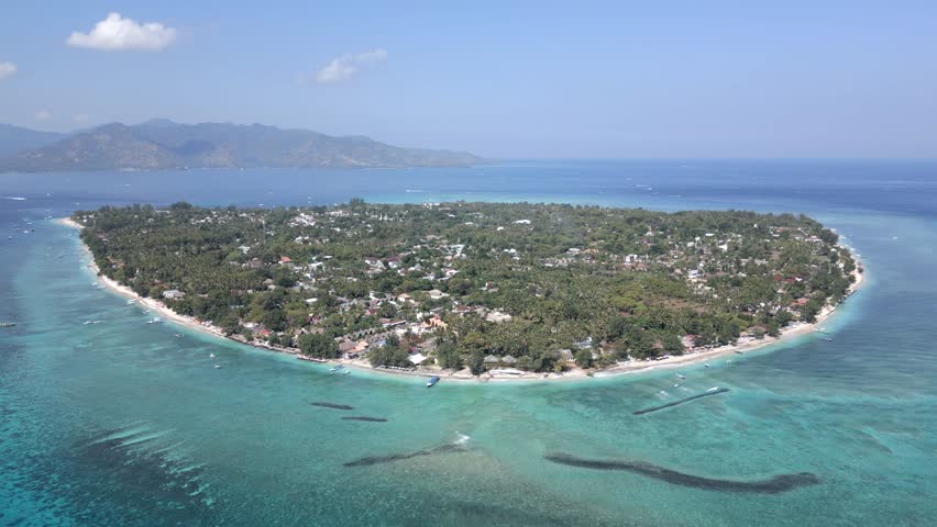 Aerial view of Gili Air island, Indonesia. Scenic tropical coastline with white sandy beaches, reef, and turquoise ocean. Paradise travel destination in Lombok region.