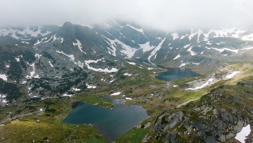 Bulgaria Seven Rila Lakes seen from above with snowmelt, jagged peaks, and pristine alpine water, ideal for clients needing remote, high-altitude, cold-season, hiking, or untouched mountain visuals