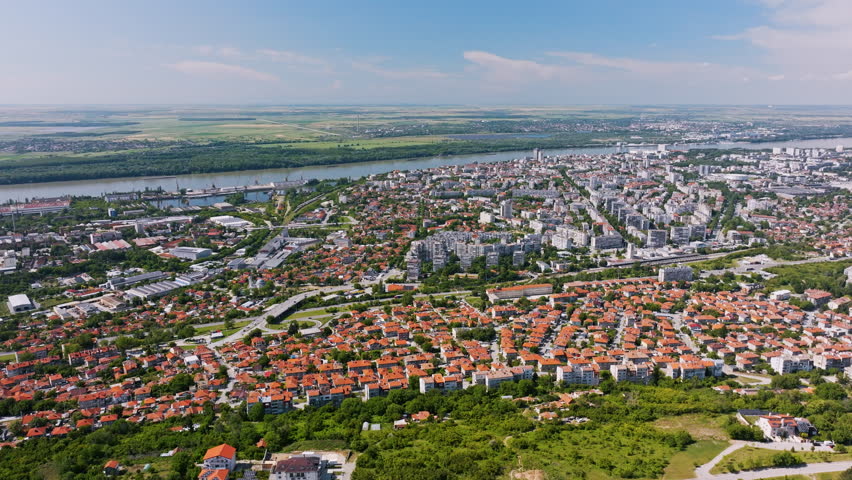 Panorama tower architecture Ruse Bulgaria seen from drone flying over city rooftops and surrounding nature, unique travel landmark ideal for stock agencies, editorial content, broadcasting, technolog