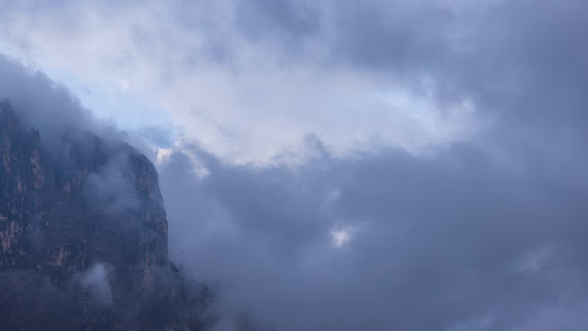 The mountains shrouded in clouds seen from San Martino di Castrozza - Italy - Timelapse