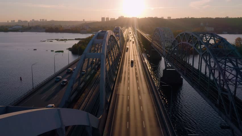 Highway bridge road with car traffic in the evening. Aerial view from above. Picturesque urban landscape in fall season.
