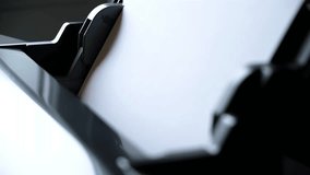 Printer paper tray close-up. Loading a sheet. Printing process. A paper comes into the color inkjet printer. Office equipment. Side view. Working B-roll. Copy space. High quality 4k footage. - Powered by Shutterstock - Get 15% off with code: PIKWIZARD15