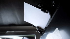 Printer paper tray close-up. Loading a sheet. Printing process. A paper comes into the color inkjet printer. Office equipment. Vertical. Side view. Working B-roll. Copy space. High quality 4k footage. - Powered by Shutterstock - Get 15% off with code: PIKWIZARD15