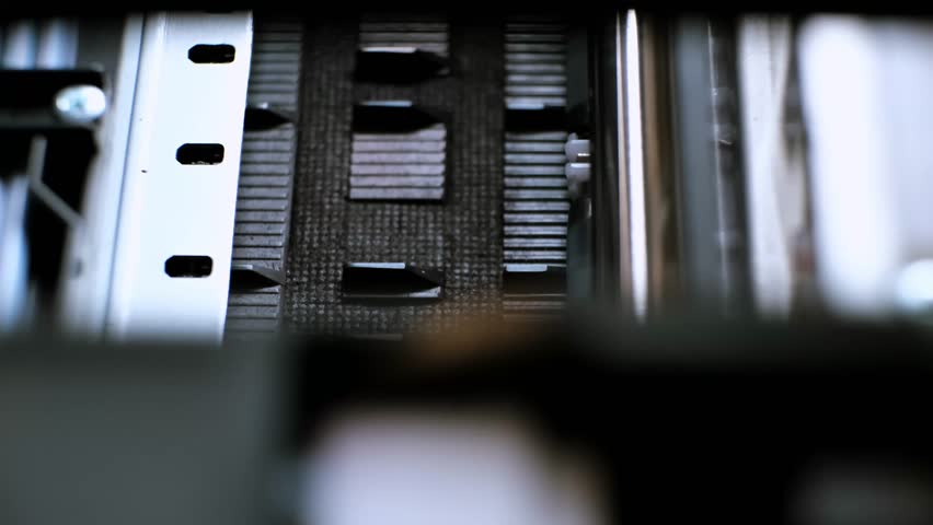 The process of printing a color inkjet printer in close-up. The rolles is rolling inside of device and printed a picture. A color calibration test. Print color chart for spectrophotometer. 4k footage.