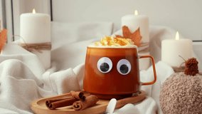 Adding cinnamon sticks Funny halloween decoration face with eyes on cup of Pumpkin spiced latte morning warming coffee. Fall Drinks for Halloween Thanksgiving Holiday beverage Autumn spicy cinnamon - Powered by Shutterstock - Get 15% off with code: PIKWIZARD15