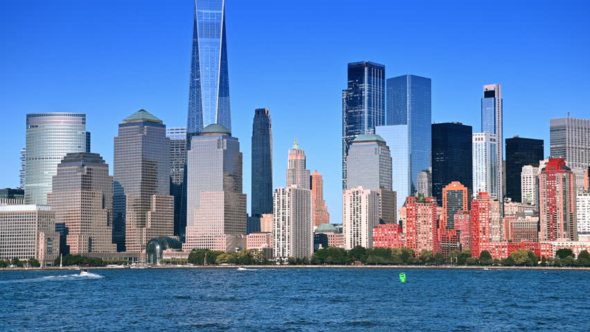 Beautiful modern buildings in the skyline of Manhattan. View on New York downtown from across the blue waterscape in Jersey, NJ, USA.