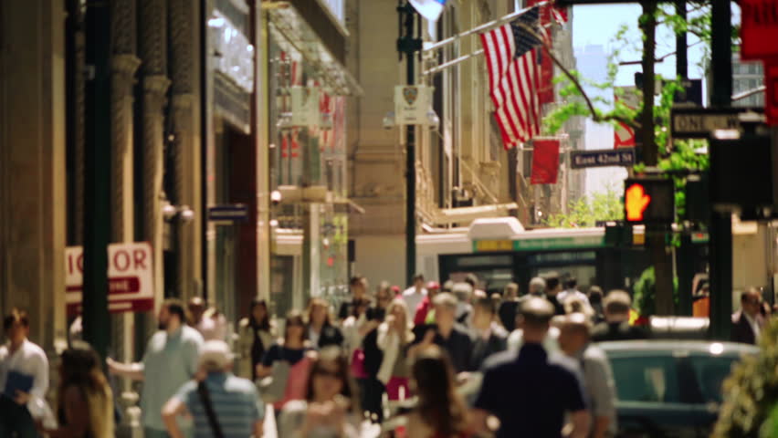 Busy Urban Street In New York City With American Flag, Crowds Of People, Traffic, Architecture And Vibrant City Life Representing Tourism, Culture, Business And Daily Urban Lifestyle.