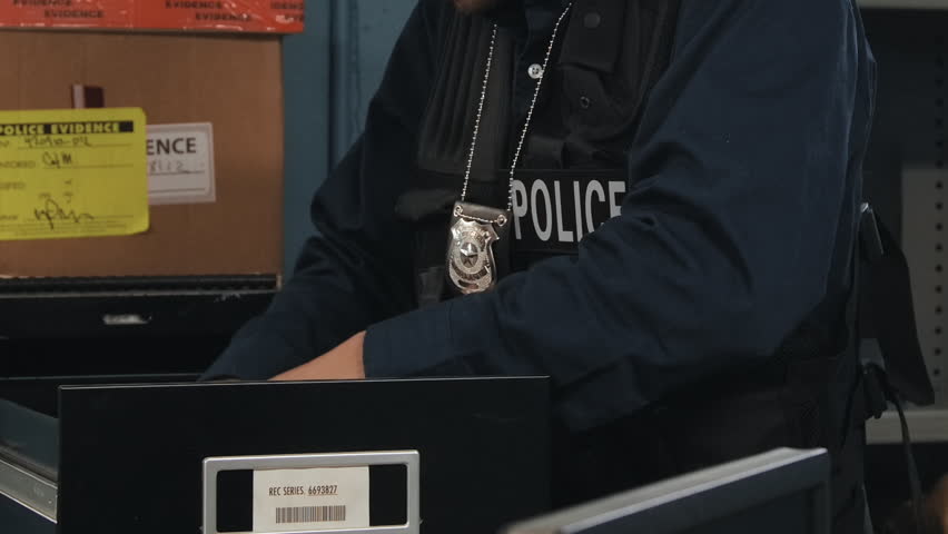 Close up police going over files