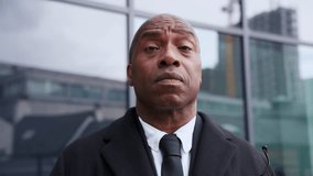 Businessman standing confidently outside a modern building in the city during daylight while wearing formal attire - Powered by Shutterstock - Get 15% off with code: PIKWIZARD15
