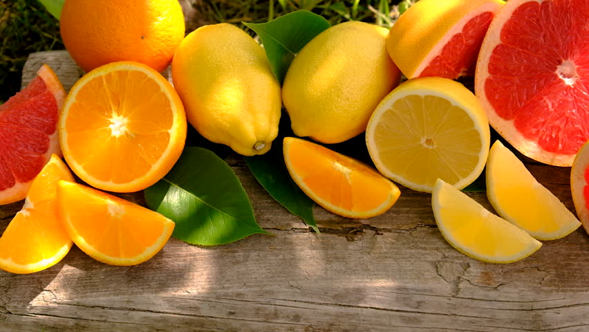 different citrus fruits sliced background. Selective focus.
