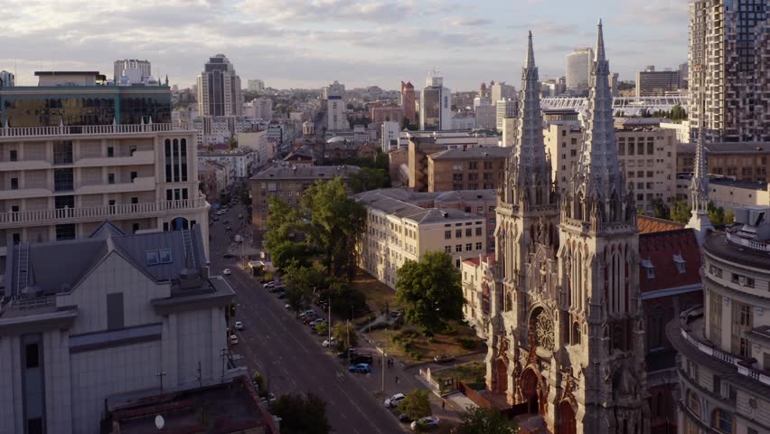 Aerial panoramic view of beautiful street and architecture of ancient and modern buildings of the European city. Gothic Revival church in Kiev.
