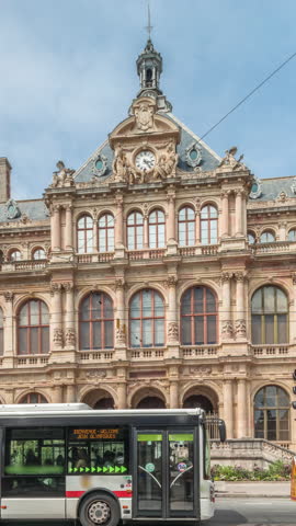 Hyperlapse of Palais de la Bourse (Palais du Commerce) front view in the Les Cordeliers quarter, Lyon, France. A historic 19th-century building with traffic passing on the street timelapse