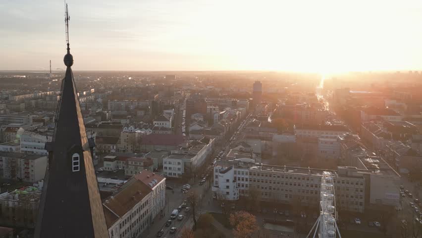Aerial zoom out view catholic cross on top of church with cityscape panorama of Siauliai city. Šiauliai Cathedral. The Church of Saints Peter and Paul. Travel destination and sightseeing attraction - Powered by Shutterstock - Get 15% off with code: PIKWIZARD15