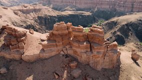 Breathtaking view of Charyn Canyon in Kazakhstan, showcasing layered sandstone formations and a meandering river - Powered by Shutterstock - Get 15% off with code: PIKWIZARD15