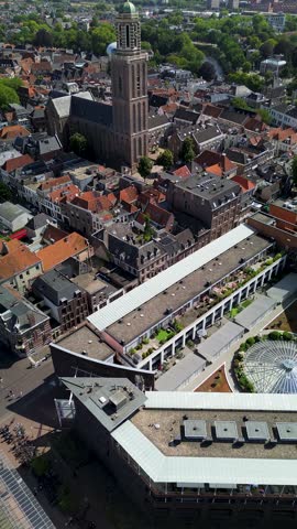 Utrecht, Utrecht region, Netherlands - 09.06.2025: Aerial view of a historic European city with canals, boats, and a central square, showcasing red-roofed houses, a tall church tower