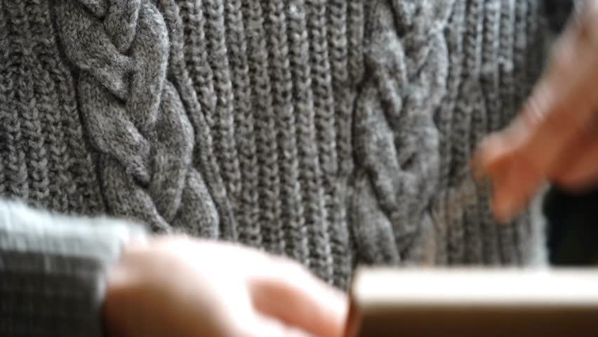 Close-Up Hand Tying Knot on Wrapped Leather Wallet Held Against Body