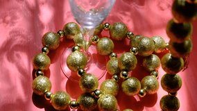 Cocktail party, Champagne flute and glitter golden beads like luxury decor, pink background, shadow and sunlight. Festive atmospheric mood - Powered by Shutterstock - Get 15% off with code: PIKWIZARD15