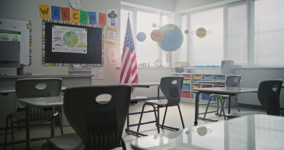 American Primary School: Interior of Modern Empty Classroom with Desks for Students, Chalkboard, Hanging Models of Solar System and Colorful Posters. Creative Space for Children Studying, Education.