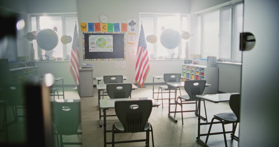 American Primary School: Interior of Modern Empty Classroom with Desks for Students, Chalkboard, Hanging Models of Solar System and Colorful Posters. Creative Space for Children Studying, Education.