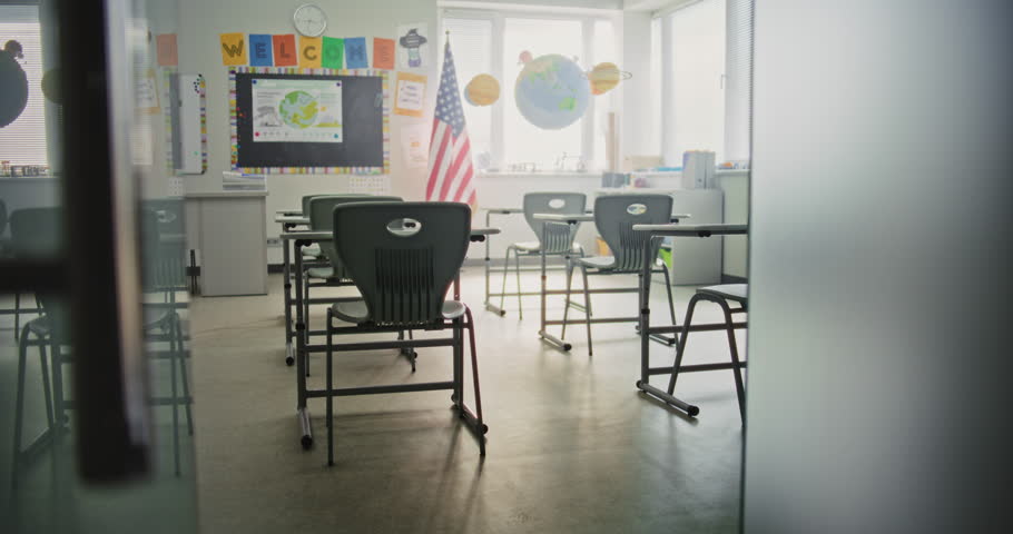 American Primary School: Interior of Modern Empty Classroom with Desks for Students, Chalkboard, Hanging Models of Solar System and Colorful Posters. Creative Space for Children Studying, Education.