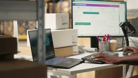 Black employee works with AI tools to enhance package tracking efficiency, using machine learning and parcel tracking info to ensure seamless distribution operations in warehouse. Camera B. - Powered by Shutterstock - Get 15% off with code: PIKWIZARD15