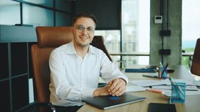 Portrait of young man working in a modern office environment, showcasing productivity and confidence during a business meeting in the afternoon - Powered by Shutterstock - Get 15% off with code: PIKWIZARD15