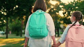 Happy children walking down street to school. Children girls go with backpacks in park. Children go with school backpacks from school home. Girlfriends girls walk down street. Children's education - Powered by Shutterstock - Get 15% off with code: PIKWIZARD15