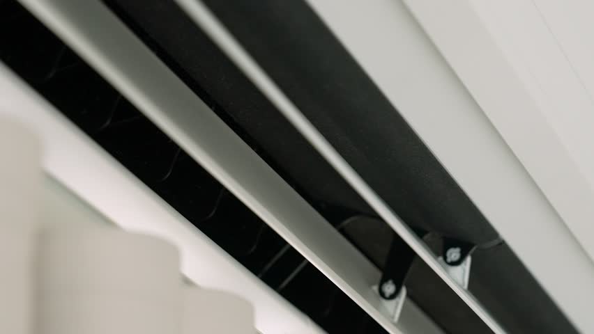 The air conditioner cools the room efficiently, using household electricity for comfort, but also releases heat outside, reminding us of energy consumption and environmental impact.
