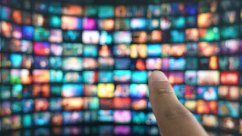 A finger hovers to select content on a vast TV display, illustrating the rise of gesture control, smart interaction, accessibility, immersive entertainment, and the evolution of user interfaces.
