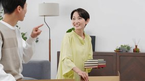 Couple packing and unpacking together at home - Powered by Shutterstock - Get 15% off with code: PIKWIZARD15