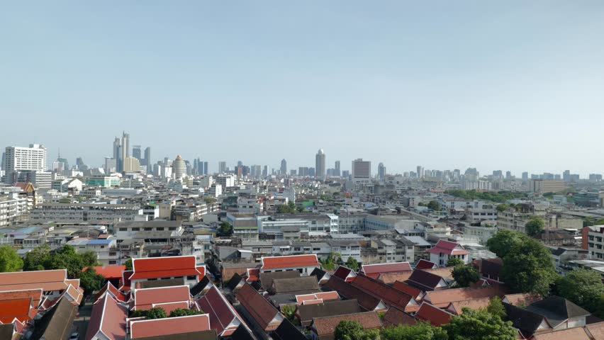 Panoramic footage of downtown Bangkok’s skyline during sunset, showcasing modern skyscrapers, high-rise buildings, and the vibrant urban landscape of Thailand’s capital city.