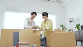 Couple packing and unpacking together at home - Powered by Shutterstock - Get 15% off with code: PIKWIZARD15