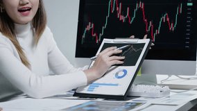 Hands using pens to point at a tablet with a rising chart, surrounded by printed reports and graphs, during a finance meeting analyzing performance and trends. - Powered by Shutterstock - Get 15% off with code: PIKWIZARD15