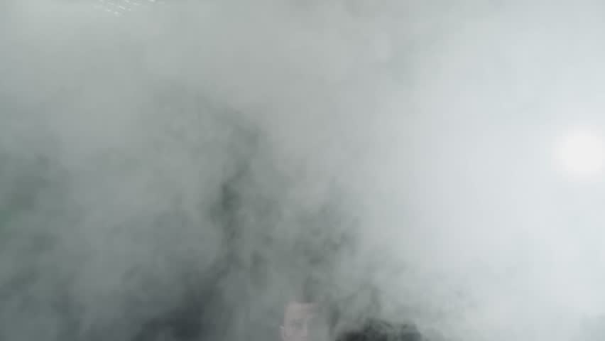 Silhouette of man jumping and punching, preparing for fight with light and fog around him. Concept of sport and healthy lifestyle. Professional boxer. 4K slow motion video