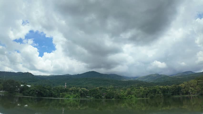 4K Time lapse of a public place leisure travel landscape lake views at Ang Kaew Chiang Mai University and Doi Suthep nature forest Mountain views spring cloudy sky background with white cloud.