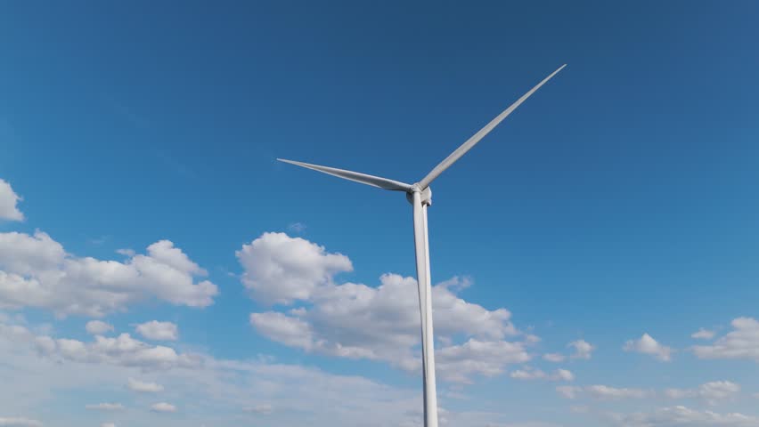 Aerial drone close-up of wind turbine blades spinning under bright blue sky. Showcasing green energy, sustainability and help preventing. climate change.