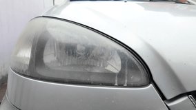 old car headlight. reflector headlight. halogen light. Matte headlight of an old SUV close-up. Dirty headlight and bumper of a white automobile. - Powered by Shutterstock - Get 15% off with code: PIKWIZARD15