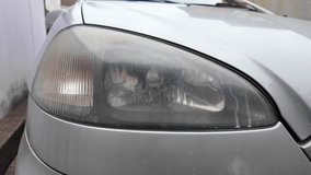 old car headlight. reflector headlight. halogen light. Matte headlight of an old SUV close-up. Dirty headlight and bumper of a white automobile. - Powered by Shutterstock - Get 15% off with code: PIKWIZARD15