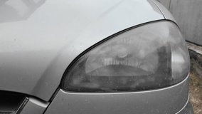 old car headlight. reflector headlight. halogen light. Matte headlight of an old SUV close-up. Dirty headlight and bumper of a white automobile. - Powered by Shutterstock - Get 15% off with code: PIKWIZARD15