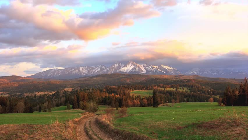 Beautiful sunrise over the Tatra Mountains. Snow-capped peaks lit by golden rays of the sun. View of the Belianske Tatras.