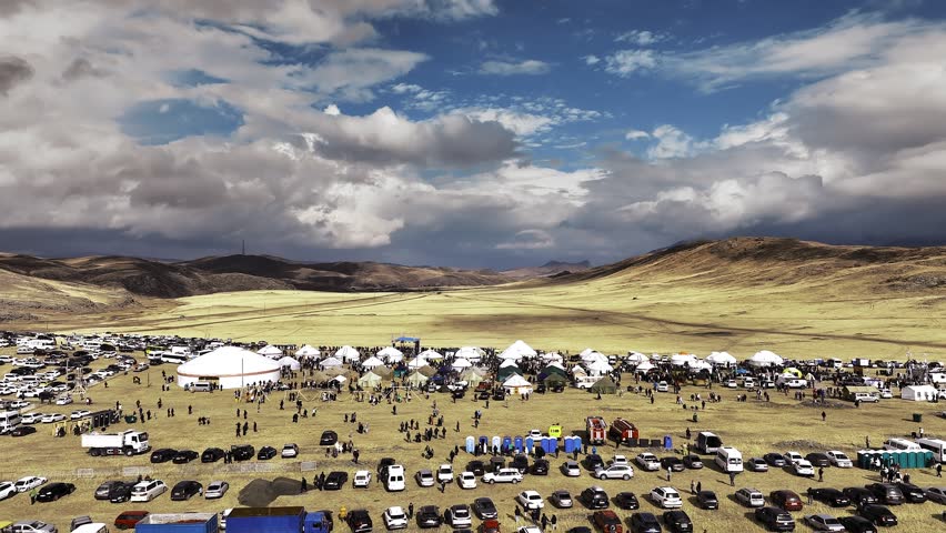 Nomadic Festival in Kazakhstan with Yurts and Cars Parked in the Steppe
