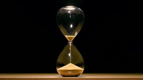 An hourglass, or a clock with sand flowing out of it, is a symbol of the passage of time. It can be used to measure time. Symbol, concept, time out, hour. - Powered by Shutterstock - Get 15% off with code: PIKWIZARD15
