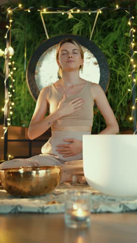 Woman practicing deep breathing during sound meditation
