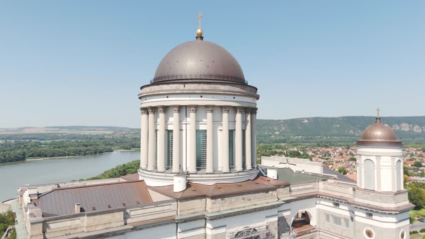 Aerial view of the dome of the Esztergom Basilica, overlooking the Danube River bend and the surrounding landscape in Hungary. Circle Dolly