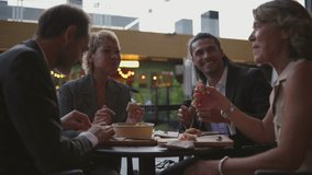 Professional team enjoying relaxed lunch break outdoors, sharing conversation and meal while sitting at table in urban setting, fostering workplace camaraderie and connection - Powered by Shutterstock - Get 15% off with code: PIKWIZARD15