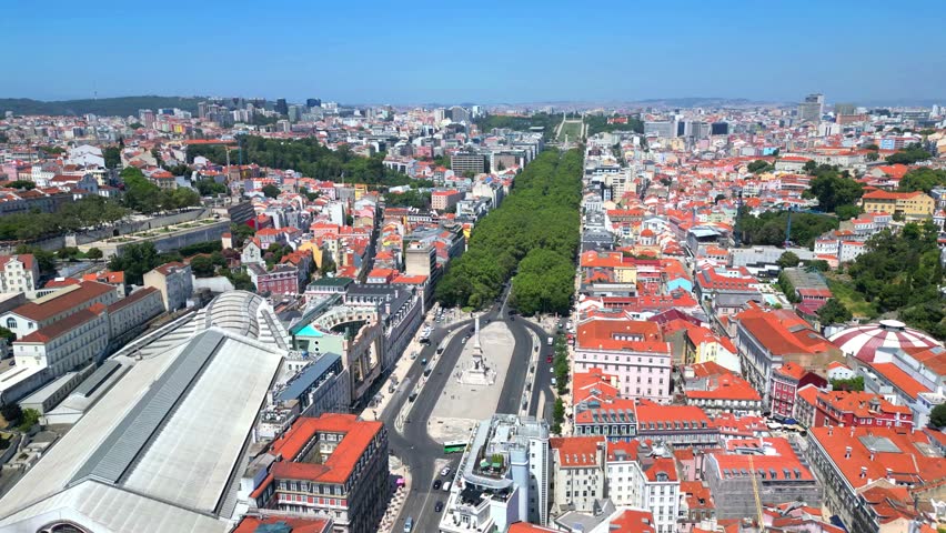 Flying towards Restauradores square with Liberdade Avenue at background and Lisbon cityscape.Portugal