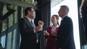 Business professionals networking and enjoying drinks at a corporate event in a modern office setting - Powered by Shutterstock - Get 15% off with code: PIKWIZARD15