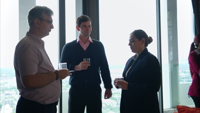 Business professionals networking and enjoying drinks at a corporate event in a modern office setting - Powered by Shutterstock - Get 15% off with code: PIKWIZARD15